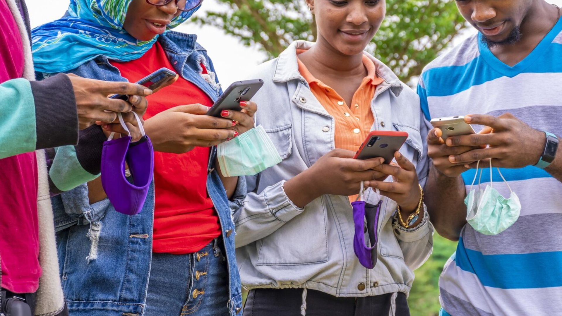 a group of young people on their smartphones 